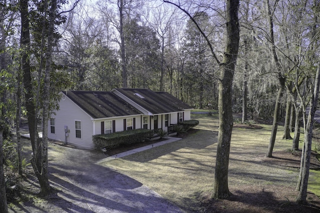 ranch-style house with dirt driveway