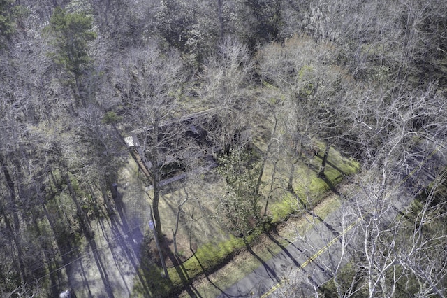 birds eye view of property with a view of trees