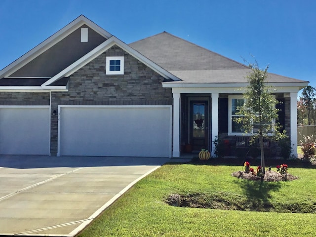 craftsman-style house featuring a garage and a front yard