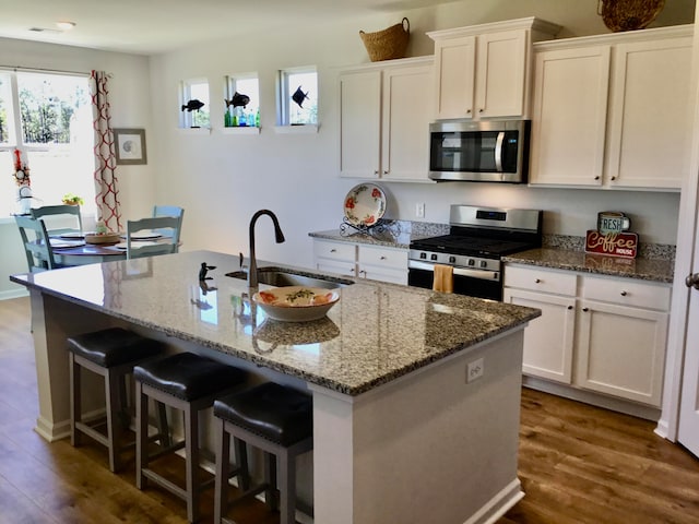 kitchen featuring white cabinets, dark hardwood / wood-style floors, sink, and appliances with stainless steel finishes