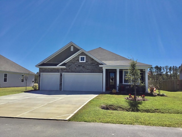 view of front facade featuring a garage and a front lawn