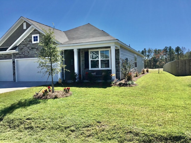 view of front of property with a front yard and a garage