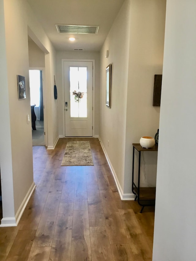 doorway to outside with wood-type flooring