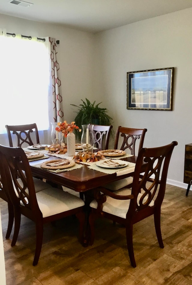 dining room with hardwood / wood-style floors