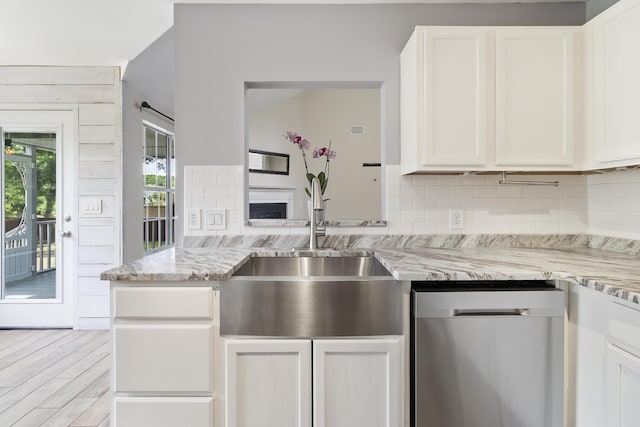 1245 Lakefront Dr, Charleston, SC 29412 - kitchen featuring stainless steel dishwasher, a sink, decorative backsplash, white cabinets, and light stone counters