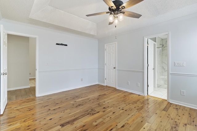 1245 Lakefront Dr, Charleston, SC 29412 - unfurnished bedroom with light wood finished floors, a tray ceiling, ornamental molding, a ceiling fan, and baseboards