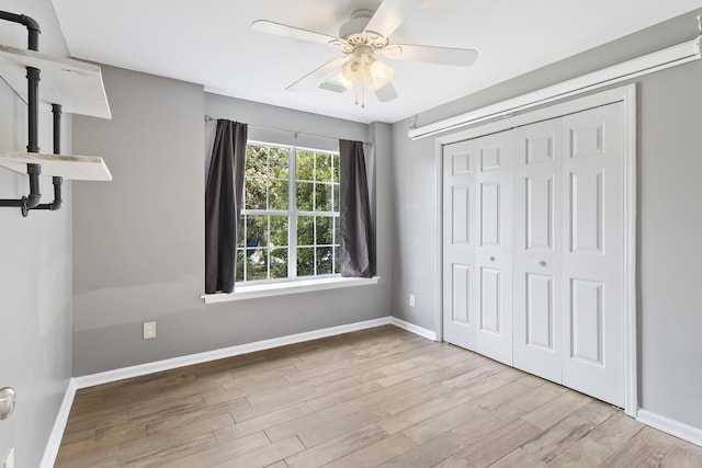 1245 Lakefront Dr, Charleston, SC 29412 - unfurnished bedroom featuring wood finished floors, baseboards, a closet, and a ceiling fan