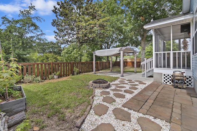1245 Lakefront Dr, Charleston, SC 29412 - view of yard featuring a sunroom, a fire pit, and a patio area