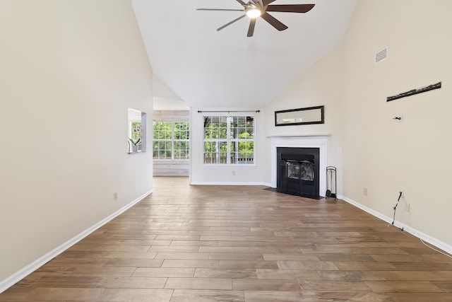 1245 Lakefront Dr, Charleston, SC 29412 - unfurnished living room featuring a ceiling fan, high vaulted ceiling, wood finished floors, and baseboards