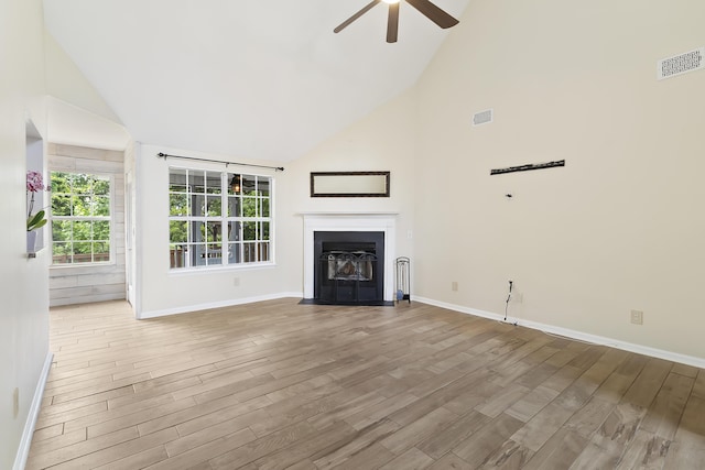 1245 Lakefront Dr, Charleston, SC 29412 - unfurnished living room with high vaulted ceiling, a ceiling fan, wood finished floors, and baseboards