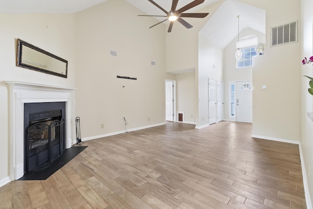 1245 Lakefront Dr, Charleston, SC 29412 - unfurnished living room with high vaulted ceiling, ceiling fan, light wood-style floors, baseboards, and a fireplace