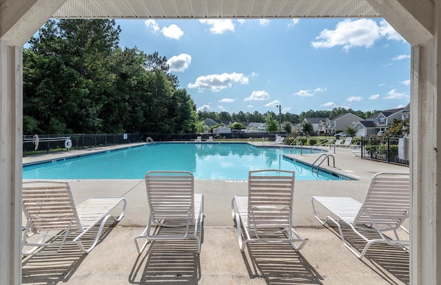 community pool featuring a patio and fence