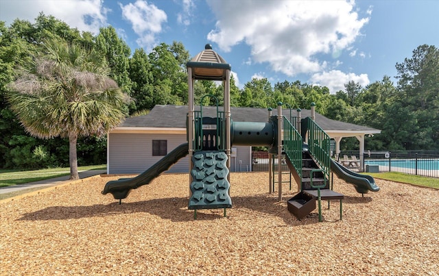 communal playground with a fenced in pool and fence