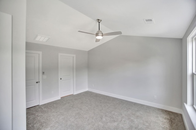 carpeted empty room with lofted ceiling and ceiling fan