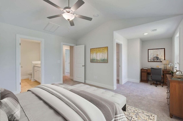 bedroom with ceiling fan, lofted ceiling, connected bathroom, and light carpet