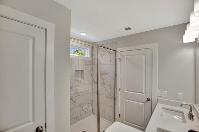 bathroom with a shower with door and vanity