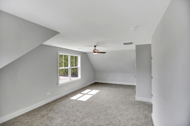 additional living space with light carpet, vaulted ceiling, and ceiling fan