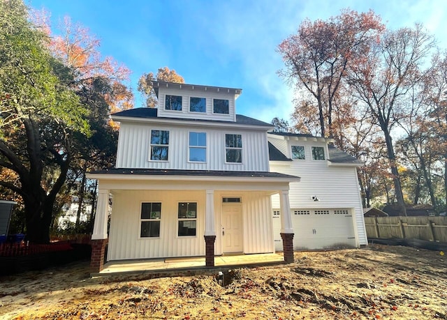 view of front of property with a garage and covered porch