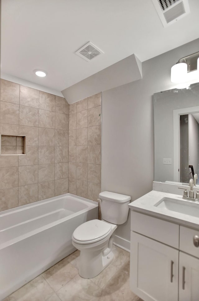 full bathroom with tiled shower / bath, vanity, and toilet