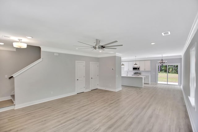 unfurnished living room featuring crown molding, sink, ceiling fan with notable chandelier, and light wood-type flooring