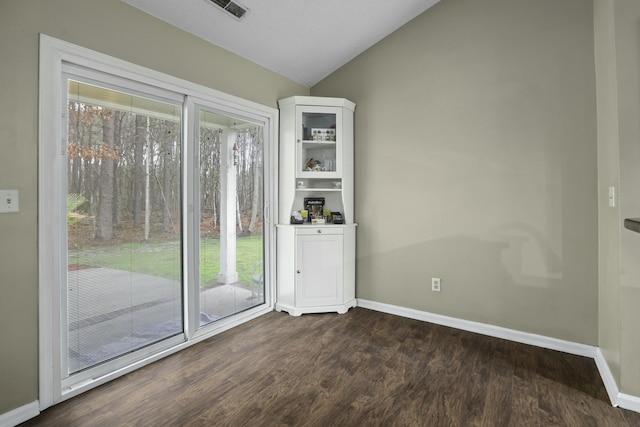 entryway with lofted ceiling, dark wood-type flooring, visible vents, and baseboards