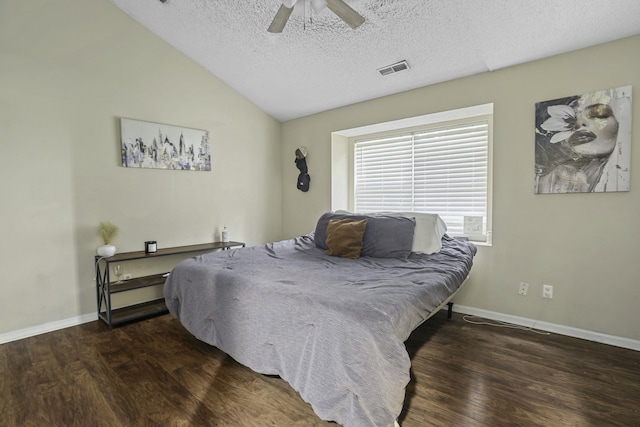 bedroom featuring baseboards, visible vents, lofted ceiling, wood finished floors, and a textured ceiling