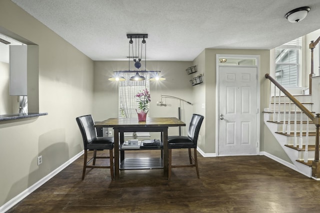 dining room with a textured ceiling, stairway, wood finished floors, and baseboards