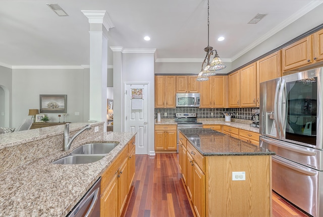 kitchen featuring visible vents, crown molding, a sink, light stone counters, and stainless steel appliances