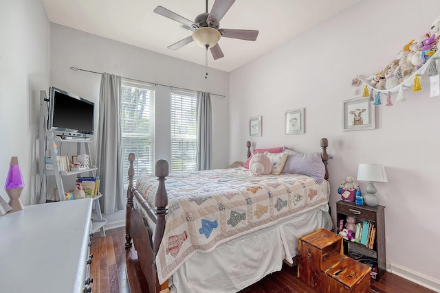 bedroom with a ceiling fan, baseboards, and wood finished floors