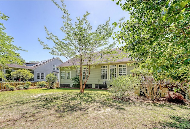 rear view of house with a yard