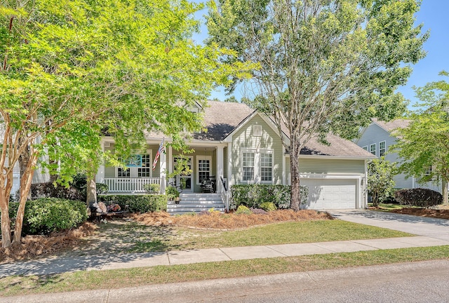 obstructed view of property featuring roof with shingles, covered porch, an attached garage, and concrete driveway