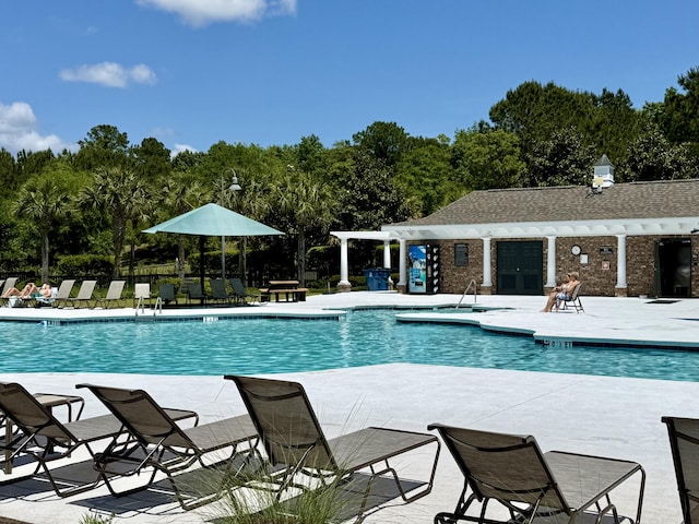 community pool featuring a patio area and fence