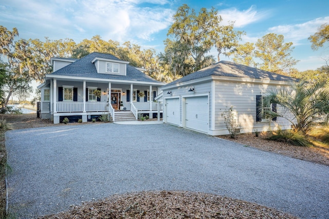 view of front of home featuring covered porch and a garage