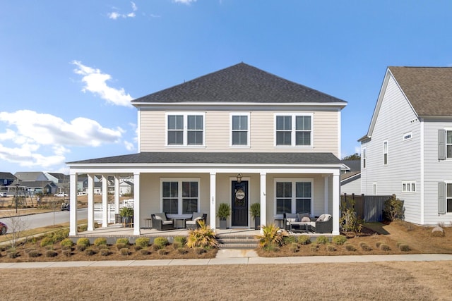 view of front of property featuring roof with shingles and covered porch