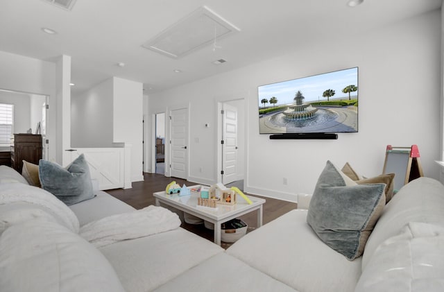 living area featuring recessed lighting, attic access, baseboards, and wood finished floors