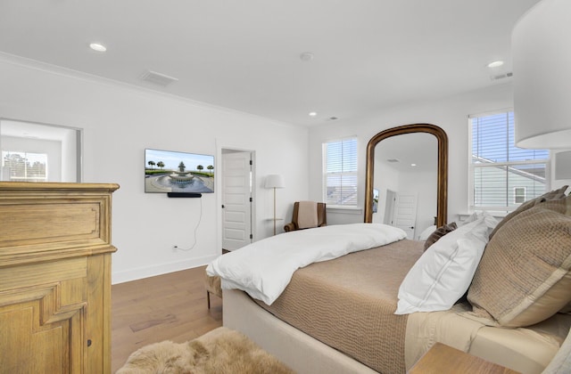 bedroom featuring recessed lighting, visible vents, multiple windows, and wood finished floors