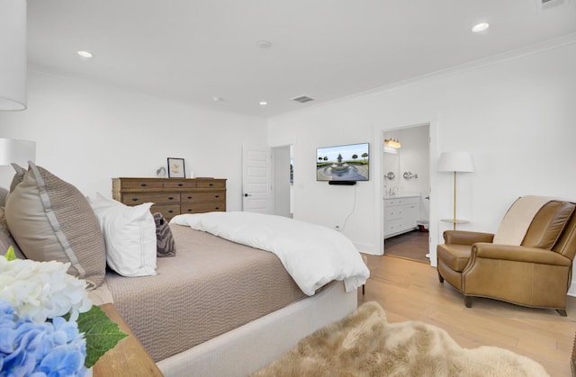 bedroom with visible vents, ornamental molding, wood finished floors, recessed lighting, and connected bathroom