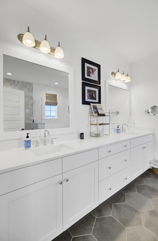 full bath featuring tile patterned flooring, a stall shower, and a sink