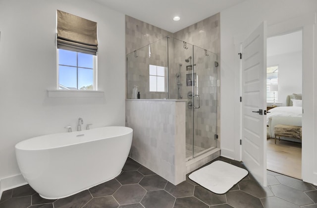 bathroom with ensuite bath, recessed lighting, a shower stall, tile patterned flooring, and a freestanding bath