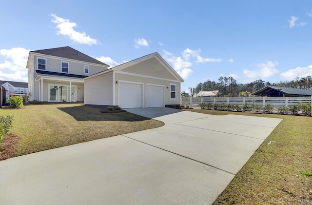 view of front of house featuring a front lawn, concrete driveway, fence, and a garage