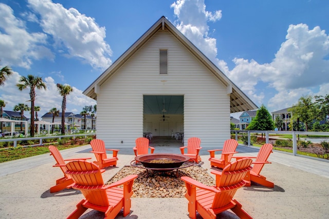 view of patio / terrace with an outdoor structure and an outdoor fire pit