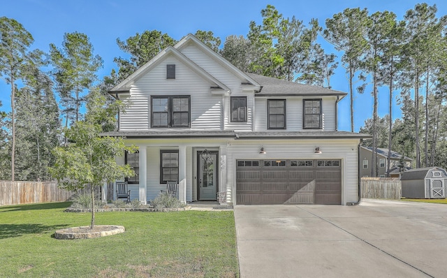 view of front facade featuring a garage, a storage shed, and a front yard