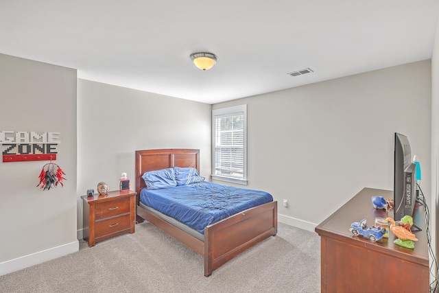 bedroom featuring light carpet