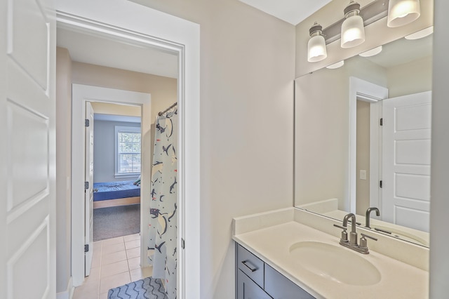 bathroom featuring tile patterned flooring and vanity