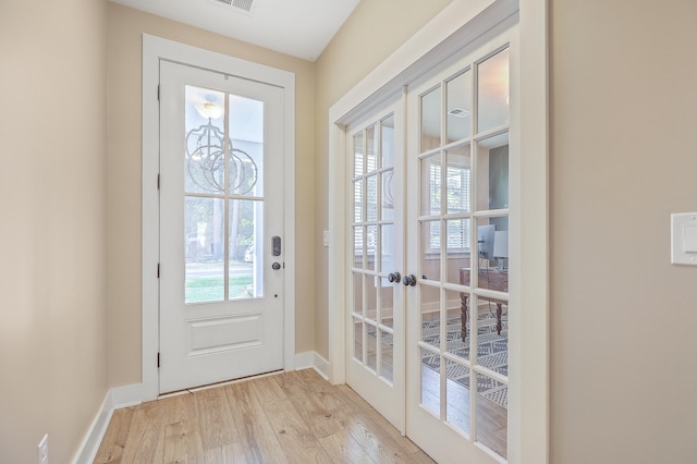 doorway to outside featuring french doors and light hardwood / wood-style flooring