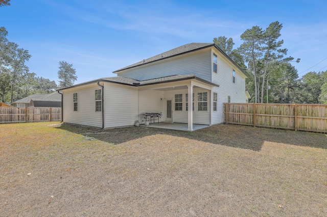 back of property featuring a lawn and a patio