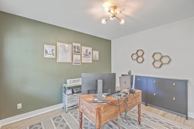 office space with a notable chandelier and light wood-type flooring