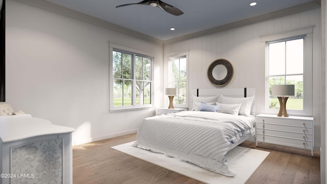 bedroom with ceiling fan and hardwood / wood-style flooring