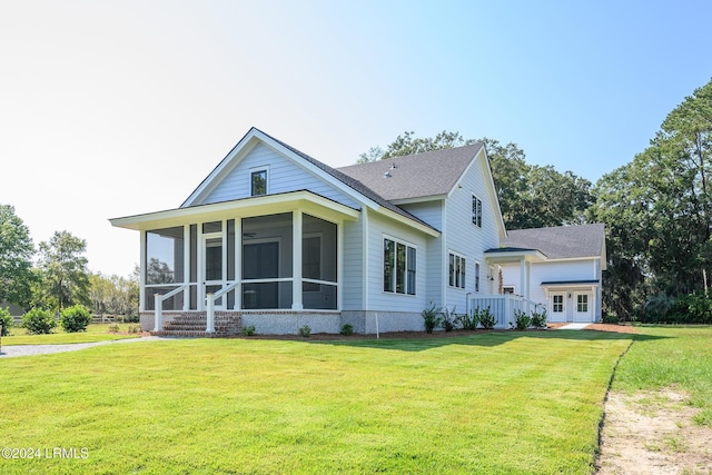 exterior space with a sunroom and a lawn