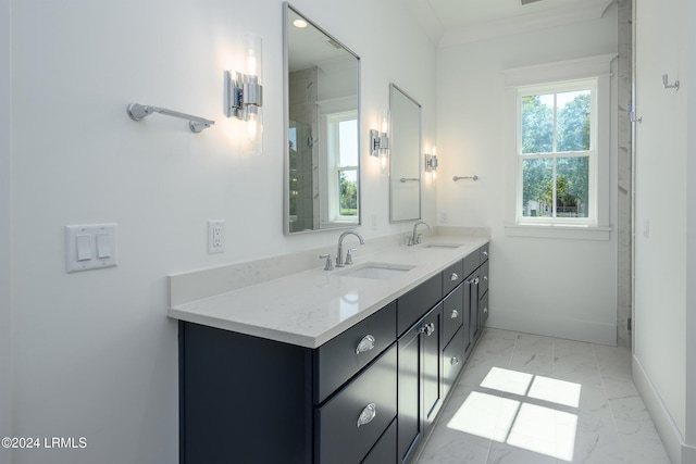 bathroom with ornamental molding and vanity